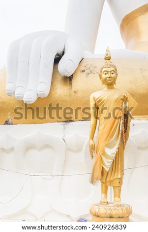 Golden Buddha statue in front of Big Buddha hand