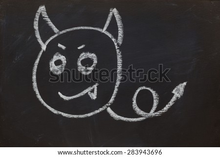 Devil smile face emotion on black chalk board