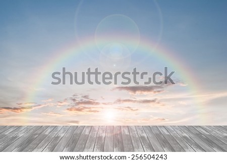 old wooden texture and rainbow  with lens flare in blue sky background