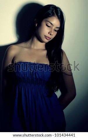 young woman with sad expression looking down