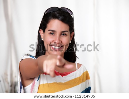 woman pointing forward with a big smile