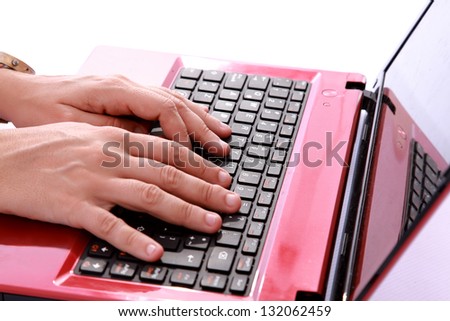 hands typing a red notebook a sign of labor and technology