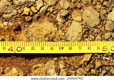 construction meter with centimeters on earth background