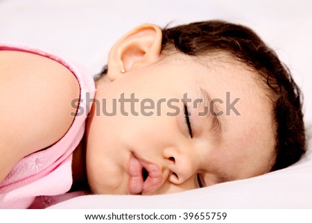 Beauty baby sleeping on white pillow. Serene scene
