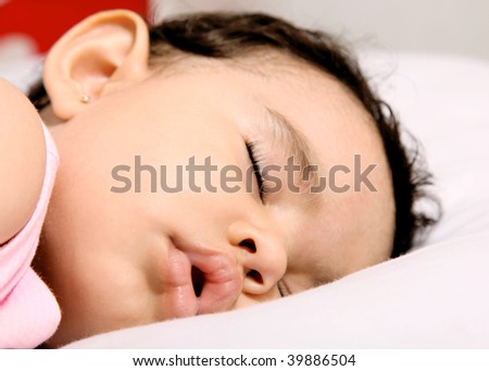 Cute baby sleeping on a white pillow