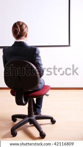 Back of a young woman in an office chair
