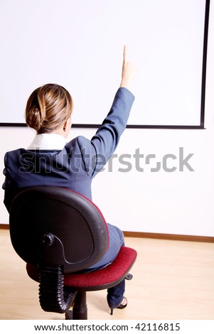 Back of a young woman in an office chair