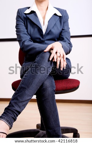 Casual woman sitting on a chair, only the bod