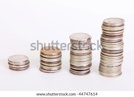 Four piles of coins on white background. Growth money
