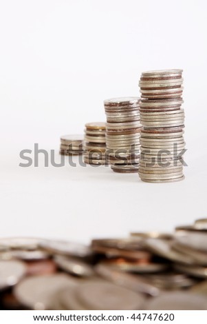Piles of coins on white background. Growth money. Selective focus