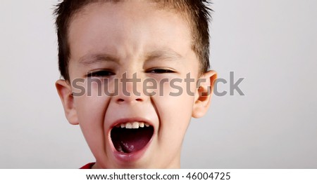 Face of a screaming child on white background.