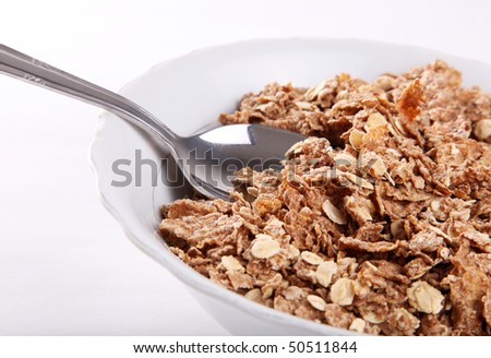 Cereal fiber on a white dish with a silver spoon