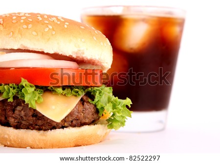 hamburger with tomato,lettuce,meat,cheese,onion with black drink over white background