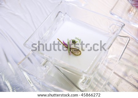 italian cuisine, a soup served in a decorated glass dish for a gastronomic competition