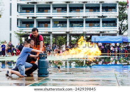 LAMPHUN, THAILAND- Jan 10, 2015:National Children's Day in Thailand.Children are doing on the fire with Fireman in Lamphun and Children's Day in Thailand on 10 January 2015.