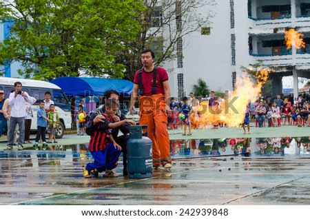 LAMPHUN, THAILAND- Jan 10, 2015:National Children's Day in Thailand.Children are doing on the fire with Fireman in Lamphun and Children's Day in Thailand on 10 January 2015.