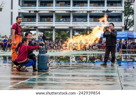 LAMPHUN, THAILAND- Jan 10, 2015:National Children\'s Day in Thailand.Children are doing on the fire with Fireman in Lamphun and Children\'s Day in Thailand on 10 January 2015.