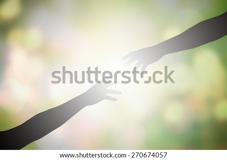 shadow  hand reaches for the  hand on blur nature background