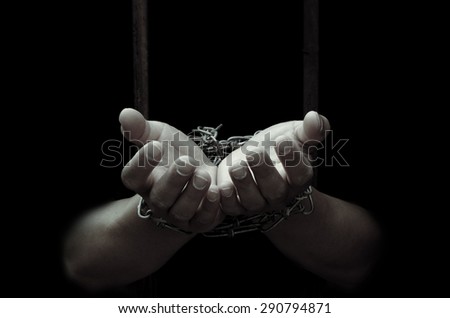 Chained hand sticking out of the priso