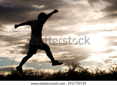 The silhouette of a man exercise on the evening before sunset.