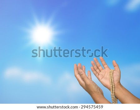 Open hand in hand with rosary prayer from the sun.