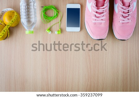 fitness concept with Exercise Equipment on wooden background.