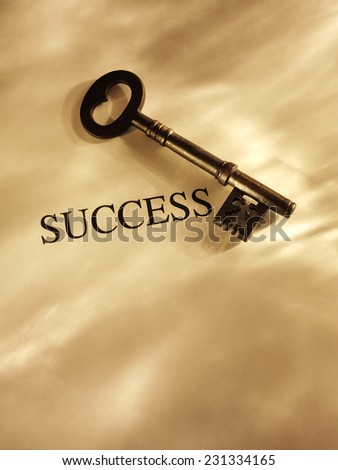 Key to Success on a Paper Background with Gold Lighting