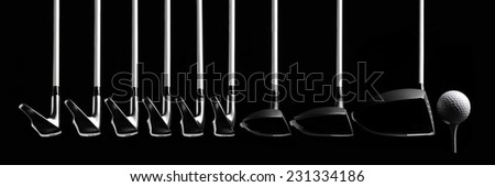 A set of Golf clubs with a Golf Ball and Golf Tee Isolated on Black