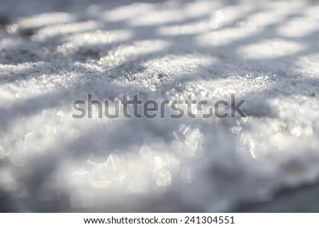 Games of light and shadow on a slab of snow and ice.