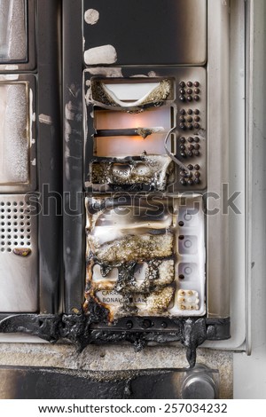 An intercom system of a building, on fire by vandals.