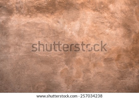An old wall color sienna, with shades of brown and yellow.