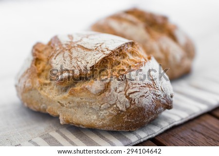 Extreme clos-up of rustic Italian bread, isolated on background out of focus.