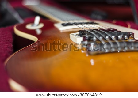Extreme close-up of an electric guitar in its carry case.