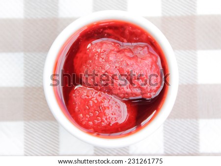 Close up of tasty and sweet strawberry jam on paper tower for snack
