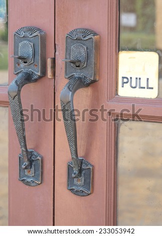 Antique and vintage door knob on wooden door for design entrance