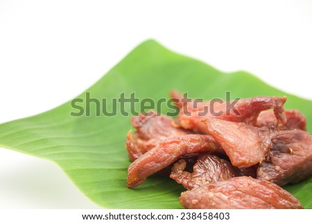 Fresh deep fried pork meat on banana leaf for food on white background