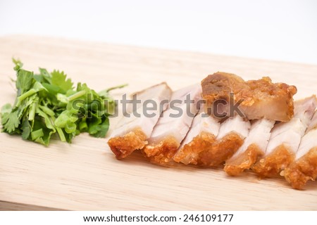 Delicious and crispy deep fried pork belly on cutting board for food on white background