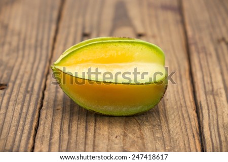 Sweet and sour star fruits or carambola brown wood for tropical food background