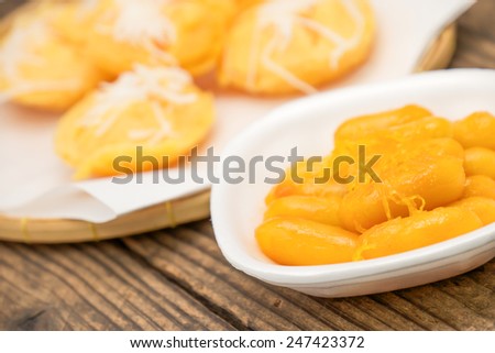 Sweet sugar palm cake with coconut topping for local thai dessert on brown wood background