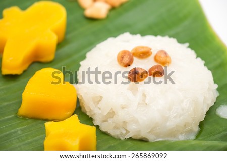 Soft focused of sticky rice with sweet mango on banana leafs for popular Thai local dessert background