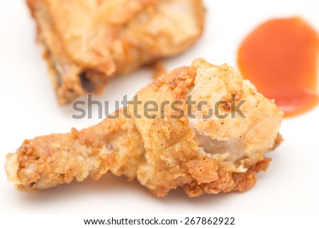 Close up of deep fried chicken with tomato sauce for food on white background