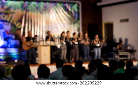 De focused or blurred people worshiping for spiritual or religion background