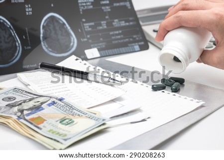 Hand pouring out pills with banknote and x ray film for medical background