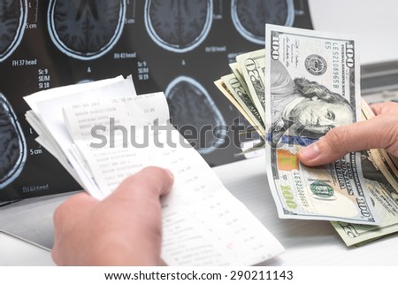 US dollar banknotes and bill with brain x ray film for medical expense background