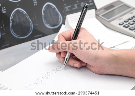 Hand writing with x ray film with calculator for medical expense background