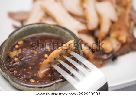 Close up of grilled sliced pork with silver fork for food background