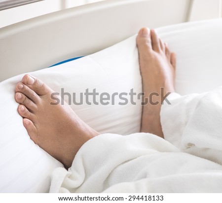 Patient's feet on bed in hospital for medical background
