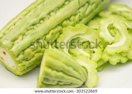 Fresh green bitter gourd or melon sliced in pieces on white background