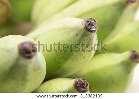 Close up of fresh ripe and raw banana for tropical fruit background