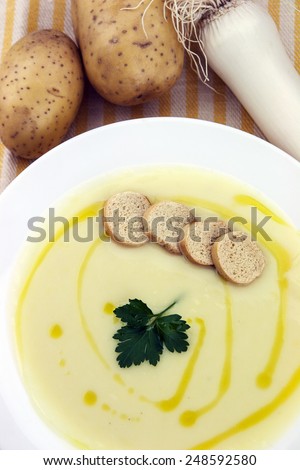 Italian potato and leek soup with olive oil, parsley and croutons